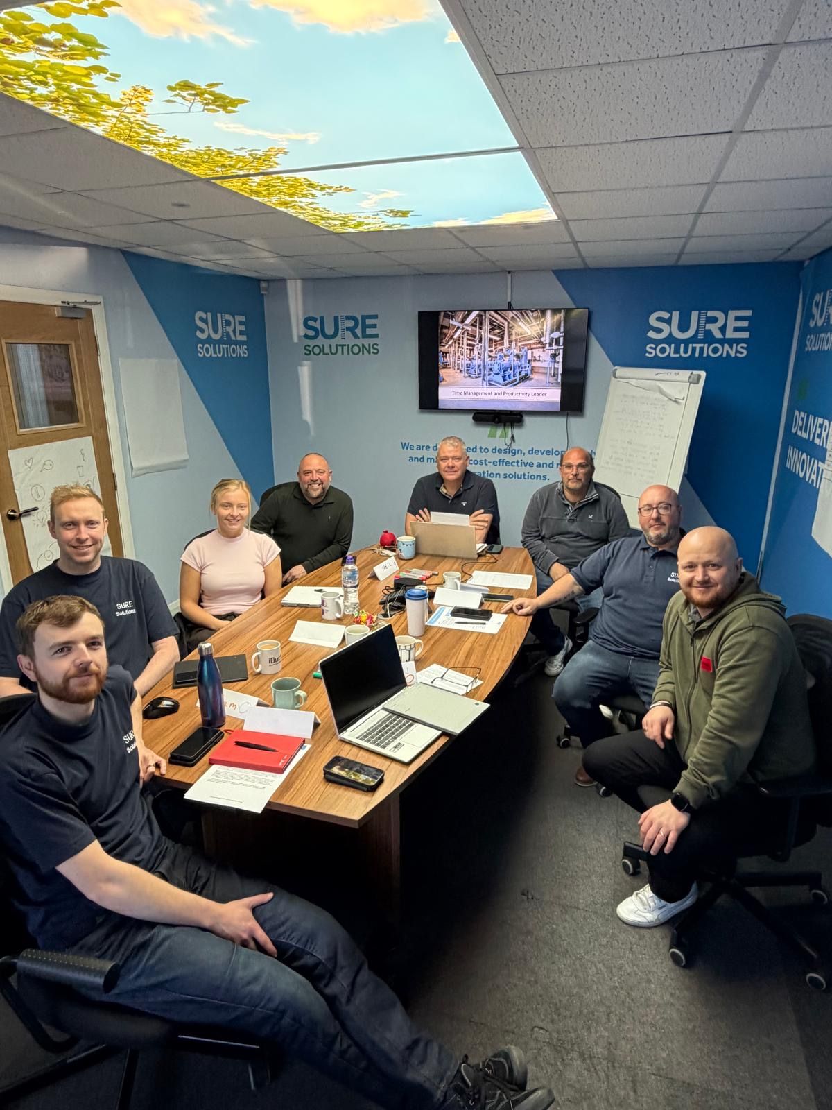 Adrian Close working with a business management team